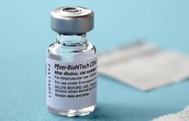 FILE – In this Dec. 14, 2020, file photo, a vial of the Pfizer vaccine for COVID-19 sits on a table at Hartford Hospital in Hartford, Conn.  (AP Photo/Jessica Hill, File) 