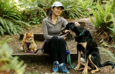 Noriko Nasu is photographed with her dogs Chico, 12, left, and Goro, 15 months, right, at Seattle’s Carkeek Park Tuesday, May 4, 2021. 217029