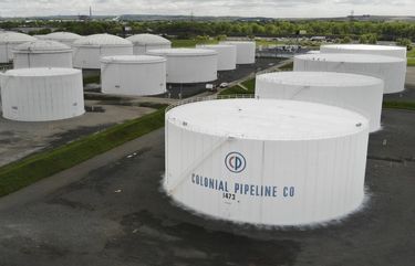 Colonial Pipeline storage tanks are seen in Woodbridge, N.J., Monday, May 10, 2021. Gasoline futures are ticking higher following a cyberextortion attempt on the Colonial Pipeline, a vital U.S. pipeline that carries fuel from the Gulf Coast to the Northeast. (AP Photo/Ted Shaffrey) NJSW105 NJSW105