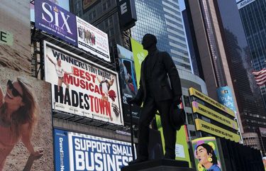 A statue of playwright and performer George M. Cohan stands in New York’s Times Square in front of billboards for Broadway shows, Thursday, May 6, 2021. Gov. Andrew Cuomo has announced that Broadway theaters can reopen Sept. 14, 2021. (AP Photo/Mark Lennihan) NYML102 NYML102