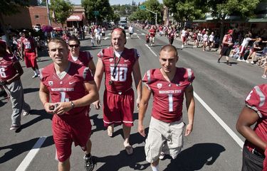 082011 – PULLMAN, WA – Washington State University football players take to the streets of Pullman, marching in the annual Lentil Festival parade.
