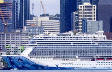 A cruise ship dwarfs a pleasure boat, as well as some of the Seattle skyline, as seen off Alki Beach Sunday, May 12, 2019 in West Seattle. 210242 210242