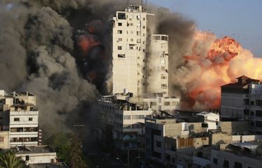 Smoke and flames rise from a tower building destroyed by Israeli air strikes amid a flare-up of Israeli-Palestinian violence in Gaza City on May 12, 2021. Israel carried out hundreds of air strikes in Gaza on Wednesday and Palestinian militants fired multiple rocket barrages at Tel Aviv and the southern city of Beersheba in the region’s most intense hostilities in years. (Ahmed Zakot/SOPA Images/Zuma Press/TNS) 16230041W 16230041W