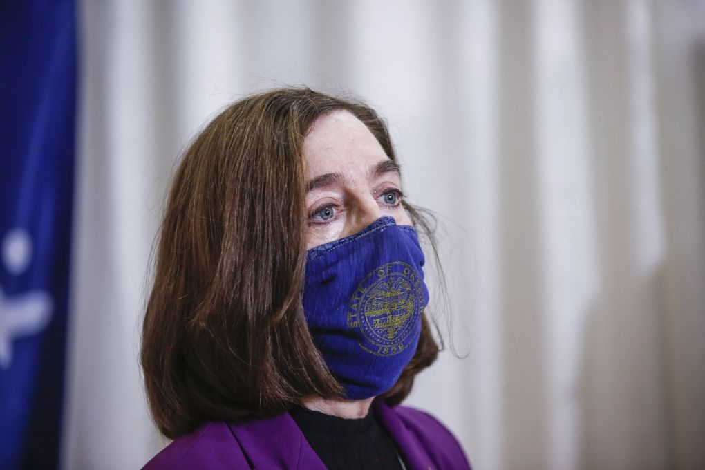 Oregon Gov. Kate Brown visits the Marion County and Salem Health COVID-19 vaccination clinic in Salem, Ore., Jan. 13, 2021. A federal judge has determined that a group of businesses and political action committees that sought to block Oregon Gov. Kate Brown’s COVID-19 restrictions haven’t shown enough evidence to prompt such a move. (Abigail Dollins / Statesman-Journal via AP, file)