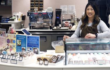 Sugar Bliss Bakery owner Teresa Ging poses for a portrait in her shop in Chicago’s famed Loop, Tuesday, May 4, 2021. In many downtown areas where companies closed their offices and commuting ground to a halt, sandwich shops, bakeries and other small businesses are waiting with guarded optimism for their customers to return. (AP Photo/Shafkat Anowar) ILSA206 ILSA206