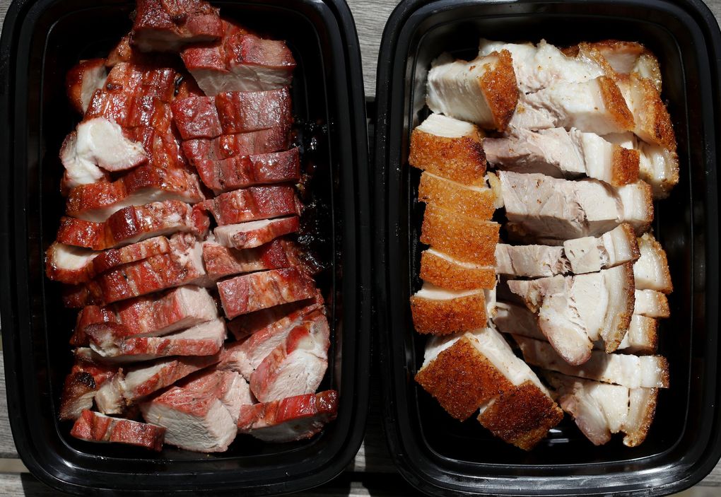Check out the honey char siu, left, and fast-selling roast pork at the new Famous Kitchen in Issaquah. (Ken Lambert / The Seattle Times)