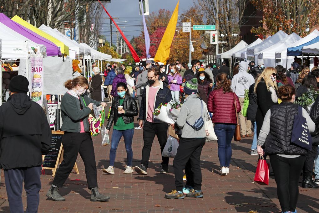 The Ballard Farmers Market, seen in November, controls crowd size and requires masks. (Ken Lambert / The Seattle Times, 2020)