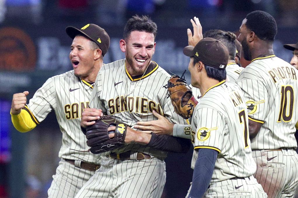 Joe Musgrove is mobbed by teammates after pitching a no-hitter against the Texas Rangers, April 9, 2021, in Arlington, Texas. It was the first no-hitter in team history for the Padres. (Richard W. Rodriguez / AP)