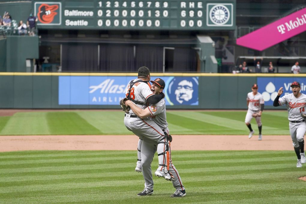 Baltimore Orioles starting pitcher John Means is hugged by catcher Pedro Severino after Means threw a no-hitter against the Seattle Mariners, May 5, 2021, in Seattle. (Ted S. Warren / AP)