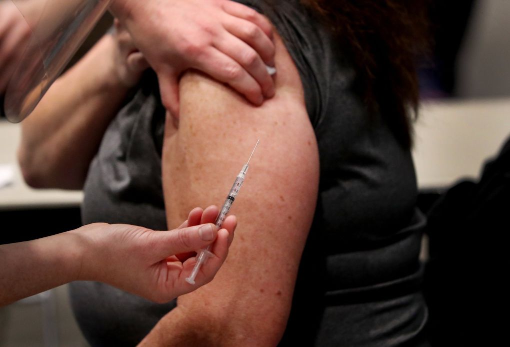 The Pfizer vaccine is given as Amazon partners with Virginia Mason creating a pop-up COVID-19 vaccine clinic at Amazon’s 7th Avenue meeting center, Jan. 24, 2021. (Ken Lambert / The Seattle Times)