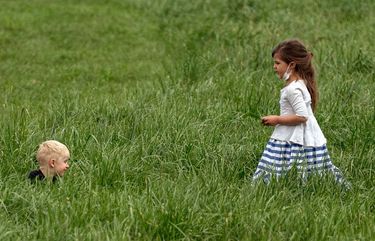 FILE — Children playing at the U.S. National Arboretum in Washington on April 18, 2021. Public health experts say being outdoors is a safer way for children to socialize. (Amr Alfiky/The New York Times) XNYT27 XNYT27