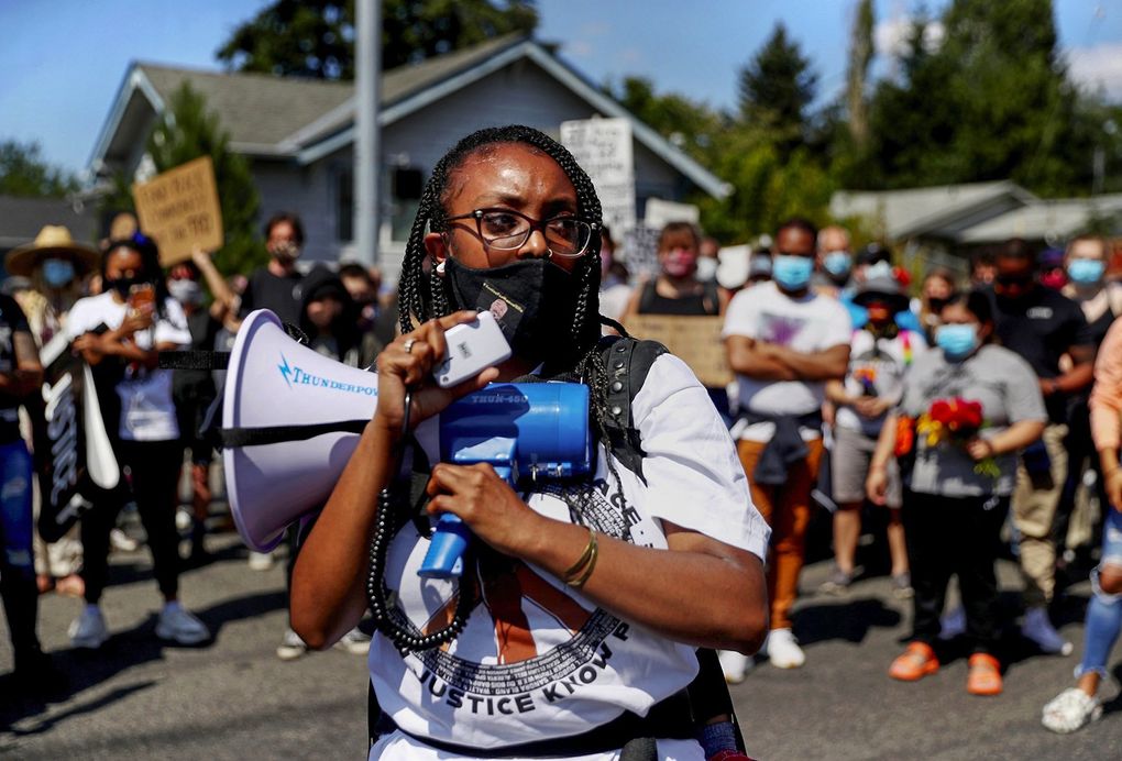 Manuel Ellis’ sister, Monet Carter-Mixon, speaks at “Manny’s Walk” in Tacoma on July 10, 2020. Hundreds walked from Ellis’ house to the intersection where he was killed in March in an encounter with police. The march was organized and planned by Carter-Mixon and supported by the Tacoma Action Collective. (Erika Schultz / The Seattle Times)