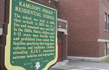 A plaque is seen outside of the former Kamloops Indian Residential School on Tk’emlups te Secwépemc First Nation in Kamloops, British Columbia, Canada on Thursday, May 27, 2021. The remains of 215 children have been found buried on the site of the former residential school in Kamloops.  (Andrew Snucins/The Canadian Press via AP) AXS111