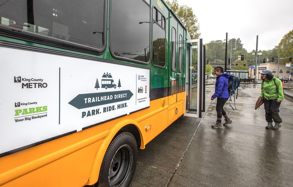 Hikers board the Trailhead Direct bus at the Mount Baker Transit Center in Seattle in April 2018. This year, the popular shuttle service will take riders to the Issaquah Alps and Mount Si on weekends and holidays from June 5 until Sept. 26. (Steve Ringman / The Seattle Times)