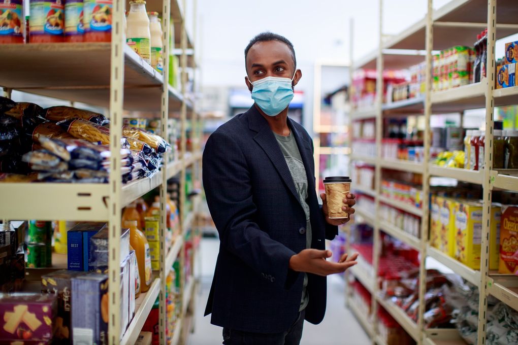 Faisal Mohamed, co-owner of the SeaTac International Mall, gives a tour of the mall’s grocery. 217135 (Erika Schultz / The Seattle Times)