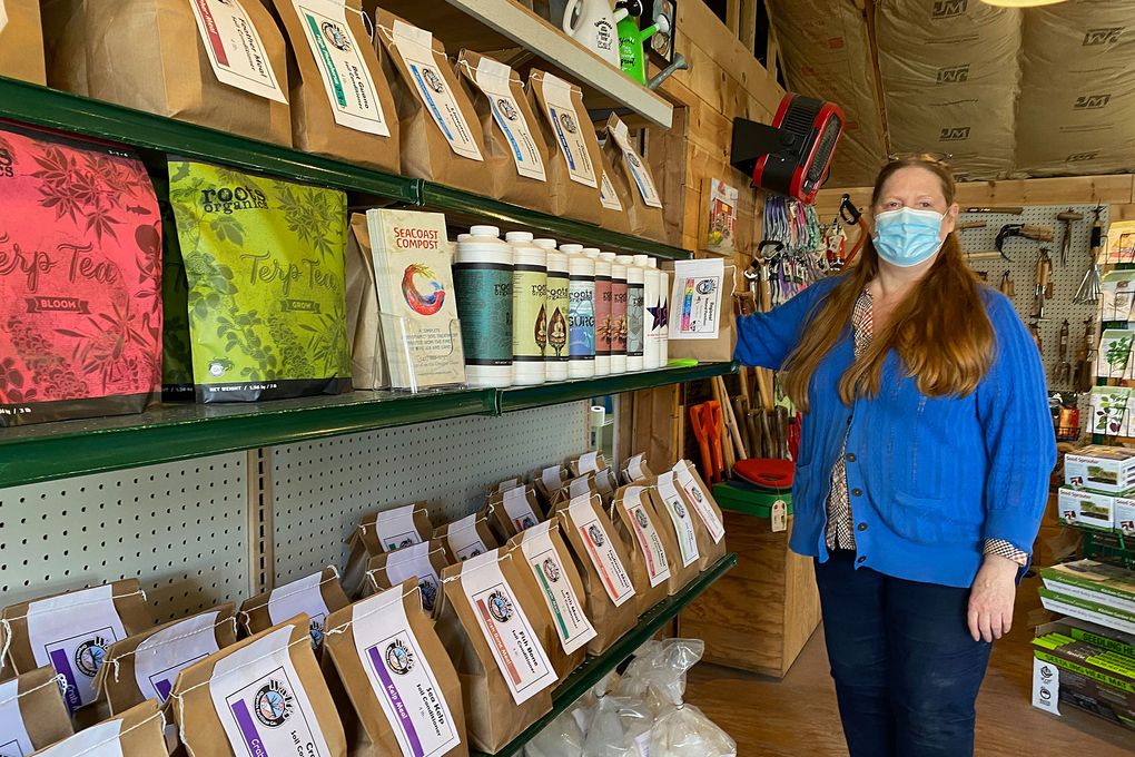 Shirley Jane Benecki, co-owner of Walt’s Organic Fertilizer Company in Magnolia, with the company’s vast array of fertilizers. (Courtesy of Karen G. Anderson)