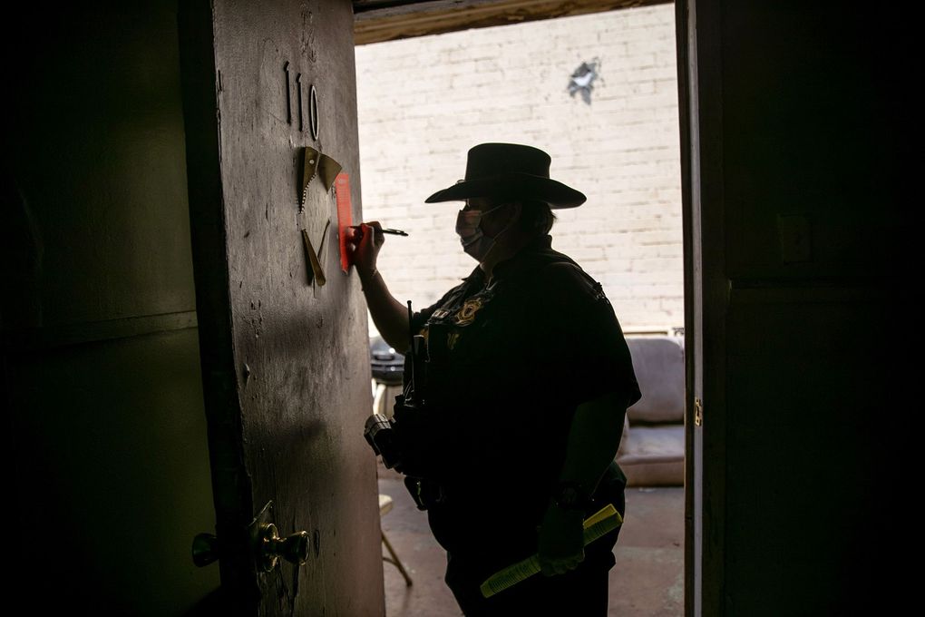 A constable signs an eviction order on October 7, 2020, in Phoenix, Arizona. (John Moore / Getty Images)