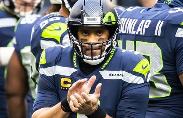 Seahawks quarterback Russell Wilson and teammates warm up before the Seattle Seahawks take on the Los Angeles Rams at Lumen Field in Seattle, Sunday December 27, 2020. 215973