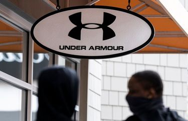 Pedestrians wearing protective masks walk past an Under Armour store in Livermore, California, U.S., on Tuesday, Feb. 9, 2021. Under Armour Inc. is scheduled to release earnings figures on February 10. Photographer: David Paul Morris/Bloomberg