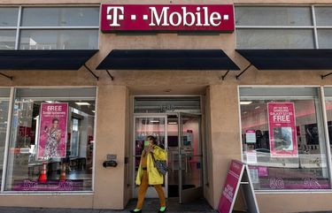 A customer exits a T-Mobile store in San Francisco in March. (Bloomberg photo by David Paul Morris)