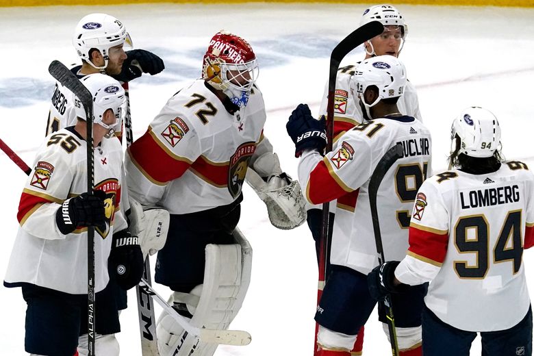 Chicago Blackhawks center Kirby Dach, right, celebrates his tying