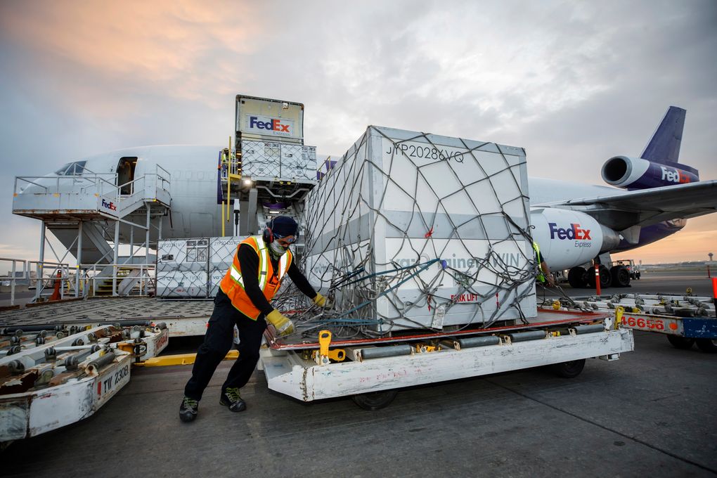 Workers unload a shipment of the Moderna COVID-19 vaccine at the FedEx hub at Pearson International Airport in Toronto on Thursday, May 20, 2021. (Cole Burston/The Canadian Press via AP)