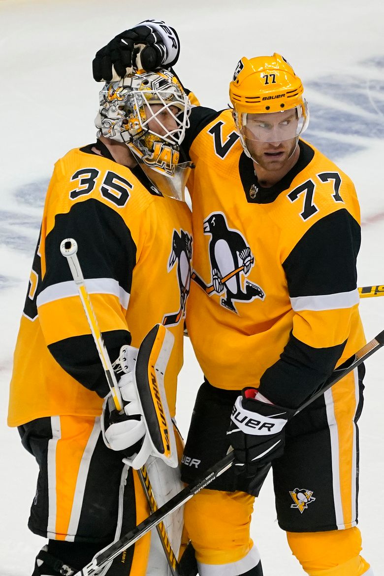 Pittsburgh Penguins' Jeff Carter (77) prepares for a face-off