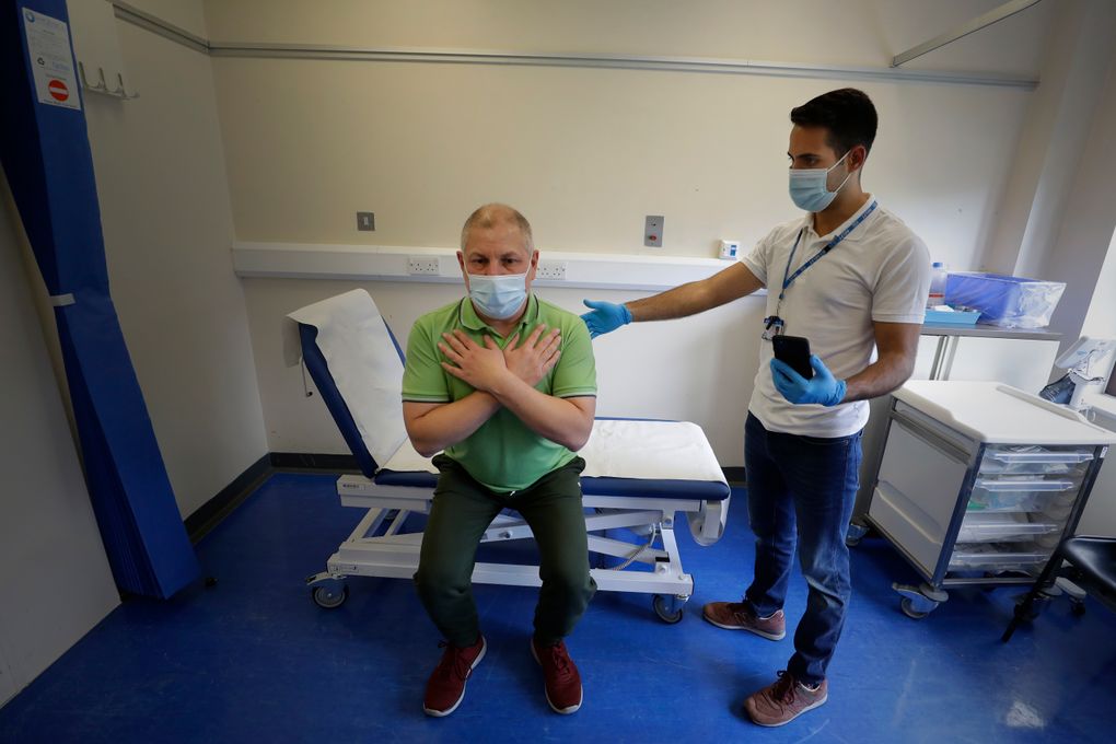 Long COVID patient Gary Miller, left, receives treatment from physiotherapist Joan Del Arco at the Long COVID Clinic at King George Hospital in Ilford, London, Tuesday, May 11, 2021. The clinic has been set up to help patients suffering months after they were infected with COVID-19. It’s one of 83 “long COVID” clinics in England where medics and patients are grappling with the enduring effects of the virus. For taxi driver Miller, recovery is agonizingly slow. He says there are times “I feel like I’m taking one step forward, and then all of a sudden — bang — I’m ill again and I take two steps back.” (AP Photo/Kirsty Wigglesworth)