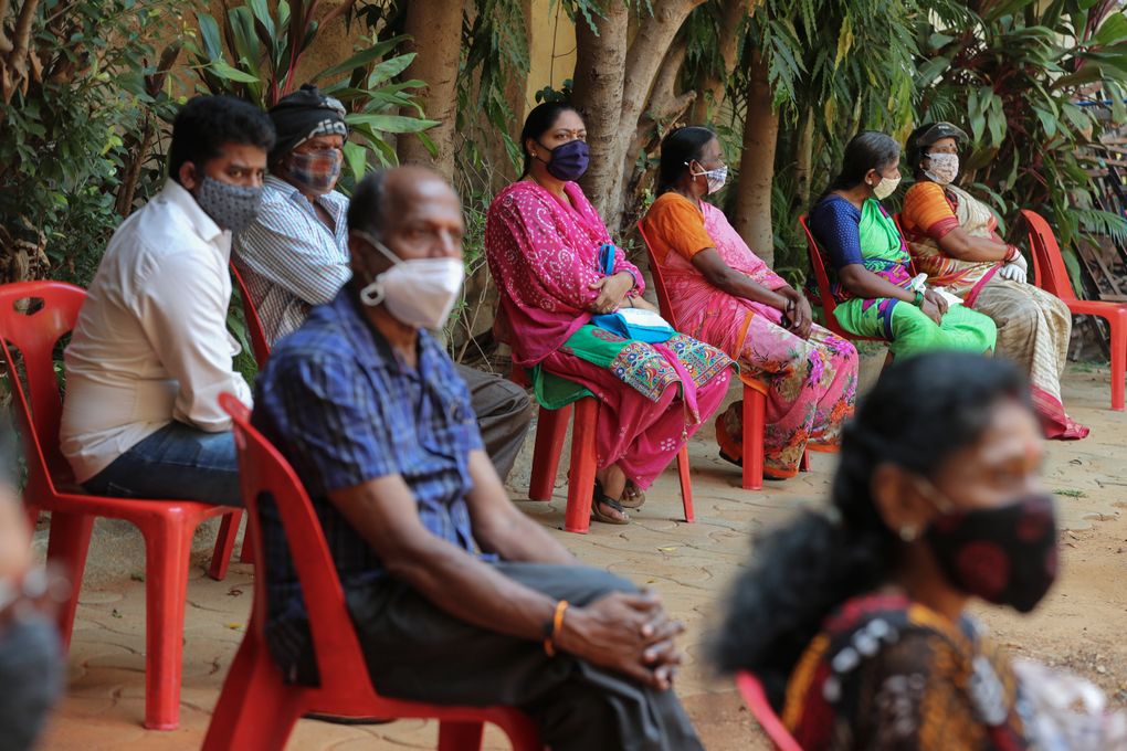 People who arrived early in the morning to get inoculated against the coronavirus wait their turn at a vaccination camp for those above age 45 being held in the premises of a school in Bengaluru, India, Wednesday, May 26, 2021. (AP Photo/Aijaz Rahi)
