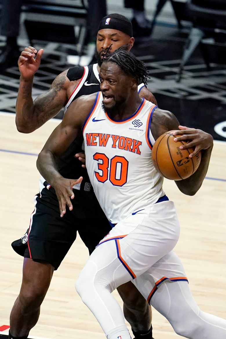 New York Knicks forward Reggie Bullock (25) slaps hands with guard Derrick  Rose (4) during the second half of an NBA basketball game against the New  Orleans Pelicans on Sunday, April 18