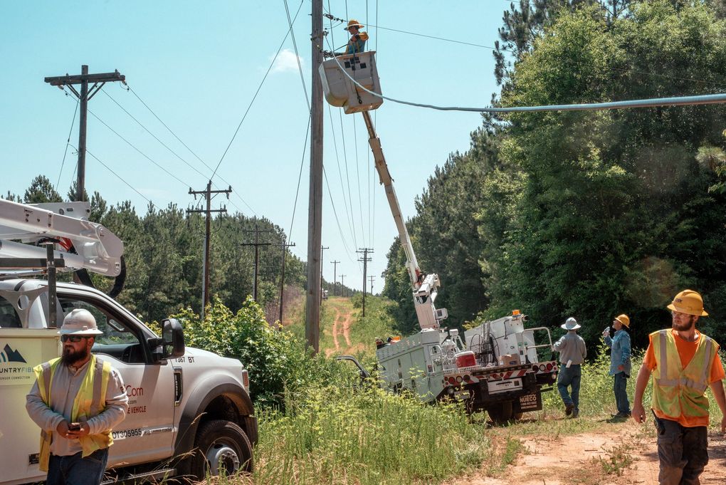 Linemen install fiber optic cable in rural Seneca, S.C., last month. About 81% of rural households have broadband internet. (Mike Belleme / The New York Times)
