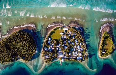 FILE — Homes on Ejit, an islet in the Majuro Atoll, Marshall Islands, pictured on Oct. 29, 2015, are under threat from rising seas. The tiny Pacific island nation faces an uncertain future. (Josh Haner/The New York Times) XNYT23