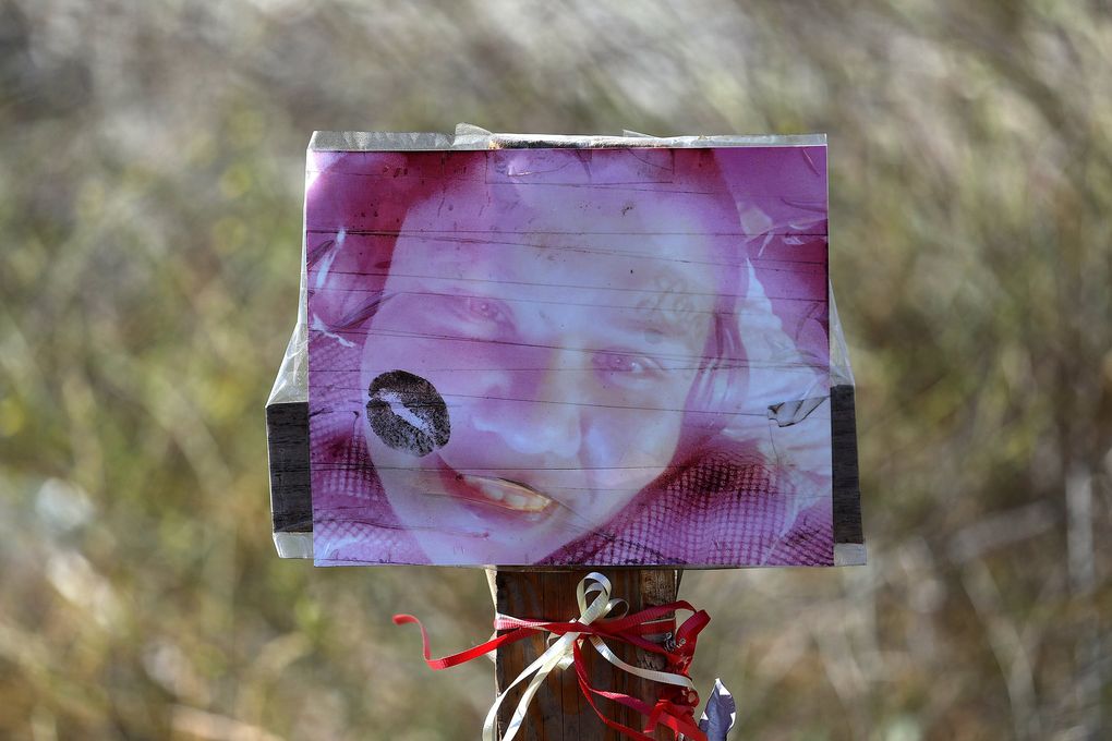 A weathered photograph is part of a memorial where the body of Patricia Loeza was found. (Gary Coronado / Los Angeles Times / TNS)