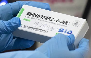 A medical worker holds a package for a Sinopharm vaccine at a vaccination facility in Beijing on Jan. 15, 2021. Two vaccines made by Chinaâ€™s Sinopharm appear to be safe and effective against COVID-19, according to a study published in a medical journal. Scientists have been waiting for more details about the two vaccines, even though they already are being used in many countries and one recently won the backing of the World Health Organization. (AP Photo/Mark Schiefelbein) XMAS202 XMAS202