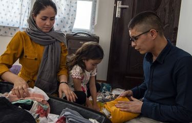 Afghan Air Force Maj. Naiem Asadi, his wife, Rahima, and their daughter, Zainab, pack their bags in Kabul on May 31, 2021, the afternoon before their departure from Afghanistan. Threatened by the Taliban and considered AWOL by the Afghan military, Asadi, a decorated helicopter pilot, fled for the United States with his wife and daughter. (Kiana Hayeri/The New York Times) XNYT33 XNYT33