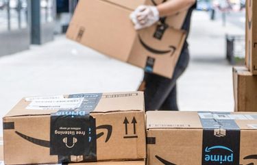 Amazon.com Inc. packages sit stacked on the sidewalk in New York. 775522633