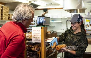 Evelyn Friske loads a tray of donuts for a customer at Friske Farm Market in Ellsworth, Mich., May 13, 2021. The family that owns Friske Farm Market sued Gov. Gretchen Whitmer last summer, arguing that wearing face masks should have remained a personal choice. (Sarah Rice/The New York Times) XNYT86 XNYT86