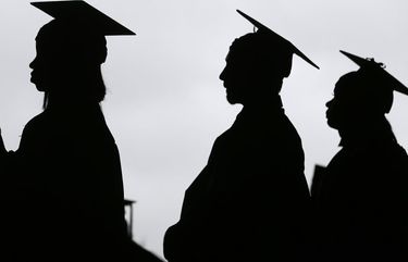 FILE – In this May 17, 2018, file photo, new graduates line up before the start of the Bergen Community College commencement at MetLife Stadium in East Rutherford, N.J. There’s no single policy or action that will alleviate America’s $1.74 trillion student loan debt crisis while simultaneously preventing students from taking on unaffordable amounts of future debt. Higher education financing experts are divided on the exact combination of solutions, but all agree it will require a multipronged approach. (AP Photo/Seth Wenig, File) NYBZ302 NYBZ302