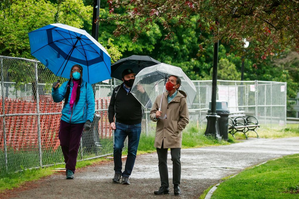 From left: Rosette Royale, story collection and engagement consultant for Seattle’s AIDS Memorial Pathway; Jason Plourde, project manager for the AMP; and Jeff Sakuma, steering committee member for the AMP, walk past where Horatio Hung-Yan Law’s “Ribbon of Light” will be installed. (Erika Schultz / The Seattle Times)