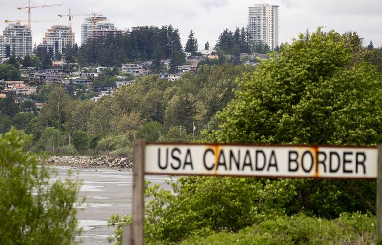 The ongoing closure of the USA-Canada border is affecting people, boaters and businesses. This sign marks the actual border at Peace Arch Park. White Rock B.C. is seen in the distance. 

