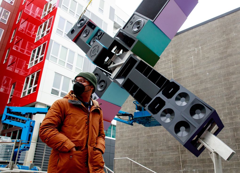 Artist Christopher Paul Jordan walks past his sculpture “andimgonnamisseverybody” during its installation at the AIDS Memorial Pathway on Capitol Hill in Seattle Monday, May 24, 2021. (Erika Schultz / The Seattle Times)