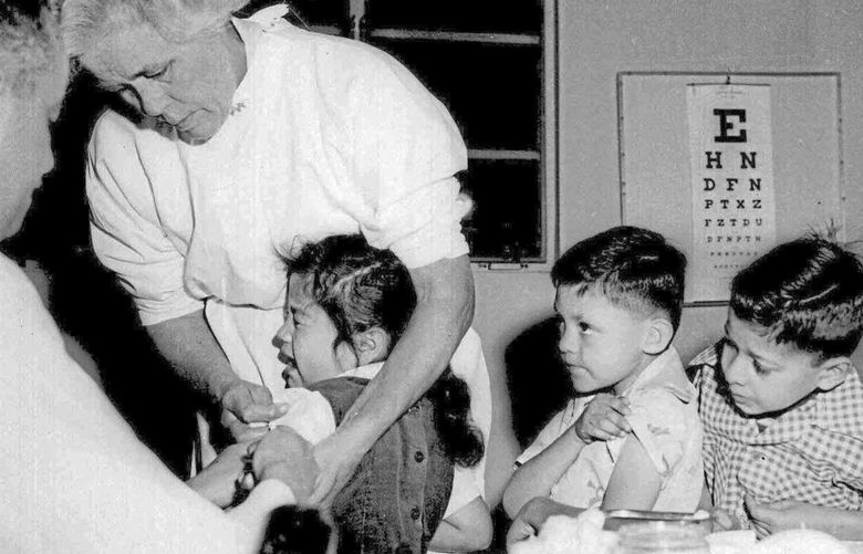 FILE – In this April 1955 file photo, first and second-graders at St. Vibiana’s school are inoculated against polio with the Salk vaccine in Los Angeles. Tens of millions of today’s older Americans lived through the polio epidemic, their childhood summers dominated by concern about the virus. Some parents banned their kids from public swimming pools and neighborhood playgrounds and avoided large gatherings. Some of those from the polio era are sharing their memories with today’s youngsters as a lesson of hope for the battle against COVID-19. Soon after polio vaccines became widely available, U.S. cases and death tolls plummeted to hundreds a year, then dozens in the 1960s, and to U.S. eradication in 1979. (AP Photo, File) PAKS802 PAKS802