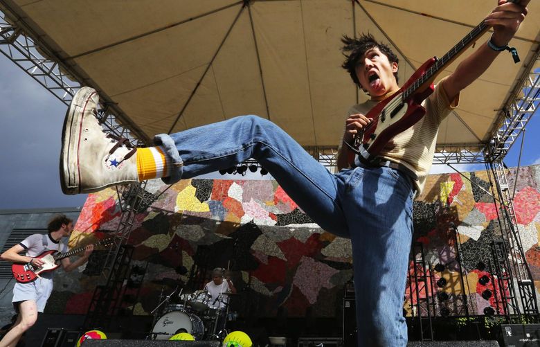 Gianni Aiello, Naked Giants bassist,, gets his rock ‘n’ roll kicks in his hightop Chuck Taylor All-Star sneakers at Bumbershoot.   The band appears this summer at ZooTunes at the Woodland Park Zoo. 216907