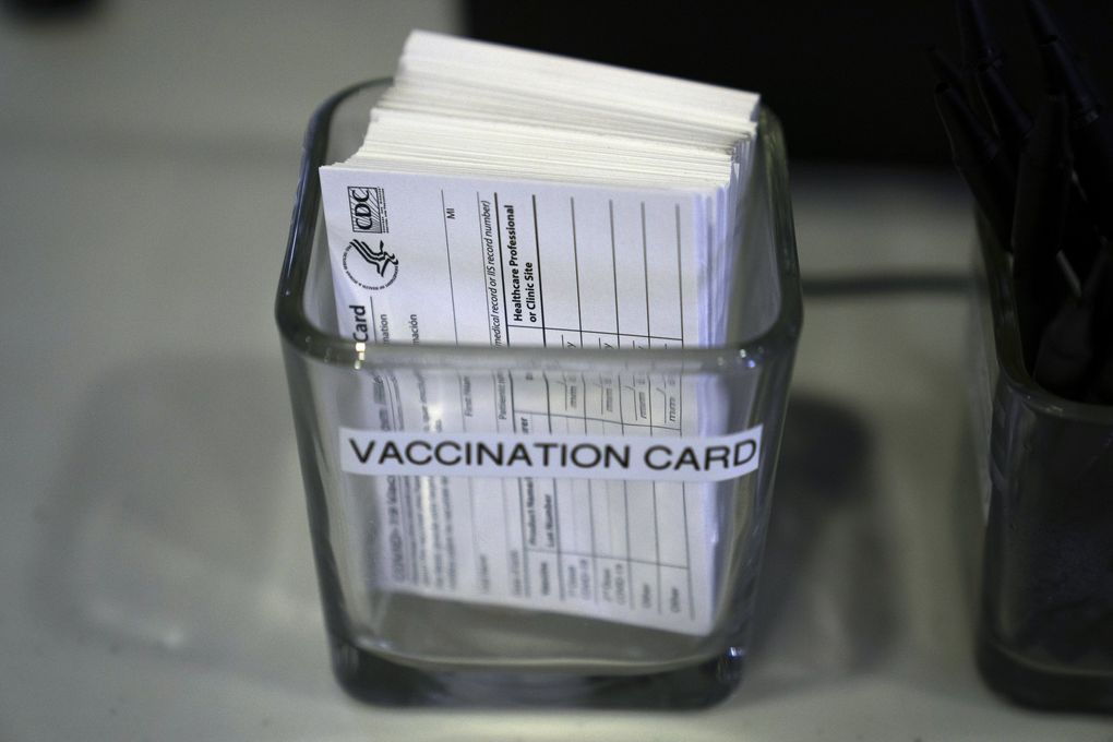 COVID-19 vaccination cards are seen in Santa Ana, Calif. A Battle Ground man employed as a Multnomah County, Ore., sheriff’s deputy is under criminal investigation over alleged misuse of vaccination cards. (Jae C. Hong / The Associated Press)