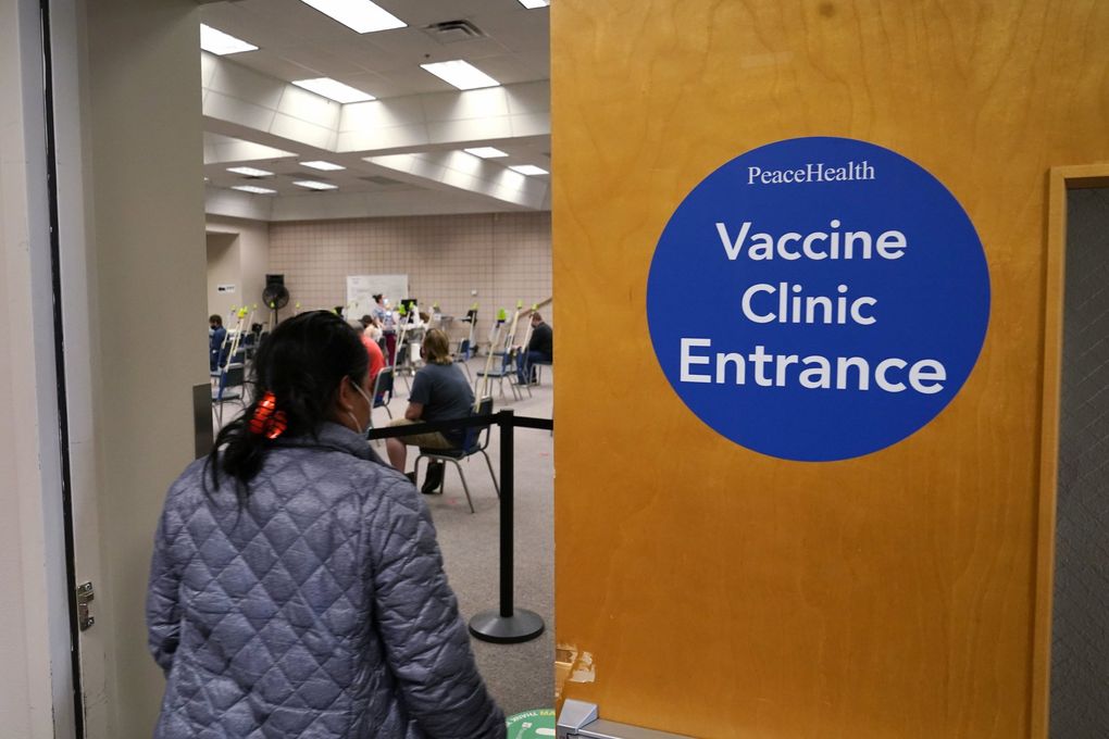 Gabina Morales heads to receive her first dose of a Pfizer vaccine at a COVID-19 vaccination clinic Thursday in Bellingham. Washington is the latest state to offer prizes to encourage people to get vaccinated against COVID-19. (Elaine Thompson / The Associated Press)