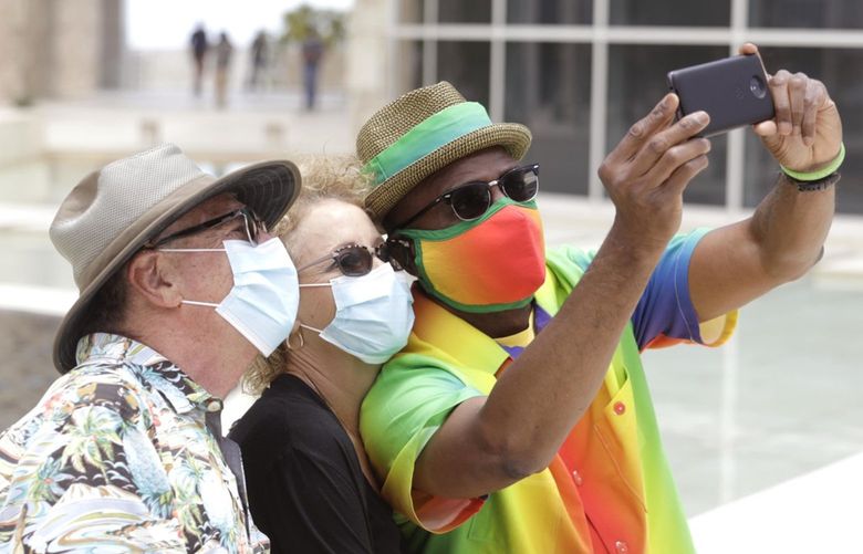Bill Mitchell, right, takes a selfie with friends Ron and Malta Tasoff, while visiting The Getty Center on the first day it reopened in over a year in Los Angeles on May 25, 2021. (Genaro Molina/Los Angeles Times/TNS) 18144696W 18144696W