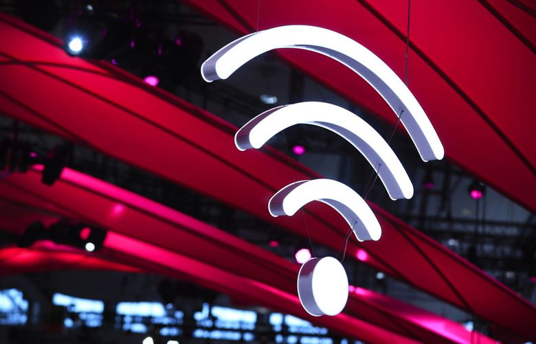 An illuminated icon representing wireless ‘wifi’ connectivity hangs from a hall ceiling at the CeBIT 2017 tech fair in Hannover, Germany, on Sunday, March 19, 2017. Photographer: Krisztian Bocsi/Bloomberg
