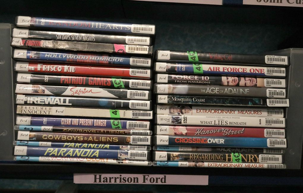 At Reckless Video, stacks and stacks of DVDs, in their slim plastic cases, are piled high on endless shelves. They are organized by genre, both straightforward and fanciful, or by actor or director or award pedigree or newness. (Greg Gilbert / The Seattle Times)