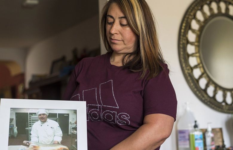 Laura Ramos holds a photo of her brother Jerry Ramos at her home in Watsonville, Calif., Sunday, June 6, 2021. He died Feb. 15 at age 32, becoming not just one of the roughly 600,000 Americans who have now perished in the outbreak but another example of the virusâ€™s strikingly uneven and ever-shifting toll on the nationâ€™s racial and ethnic groups. (AP Photo/Nic Coury) VOD309 VOD309