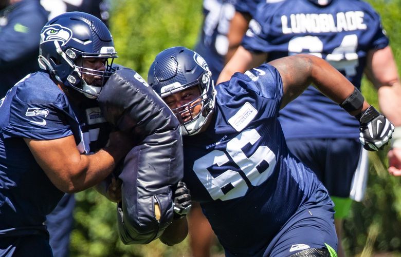 Seahawks guards Jordan Simmons, left, and Gabe Jackson work on offensive line drills at Seattle Seahawks minicamp Thursday June 17, 2021 at the Virginia Mason Athletic Center in Renton.  217410